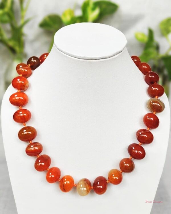 Translucent shades of ovoid-shaped toffee orange and burnt sienna coloured Onyx tumbles come together in this knotted 19” single strand necklace, with a strong spring-ring clasp for durability DN 0006