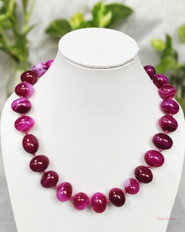 Delightfully dark shades of ovoid-shaped shocking magenta-pink coloured Onyx tumbles come together in this knotted 19” single strand necklace, with a strong spring-ring clasp for durability. DN0017