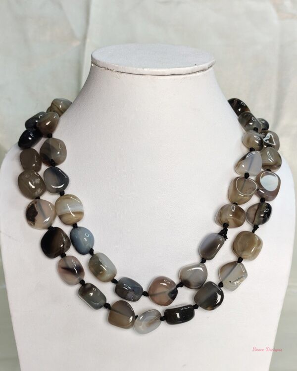 Desert Princess -Delightful irregular tumbles of Onyx in shades of chocolate browns mottled in white and black come together in this knotted 36” single strand necklace. DN0022