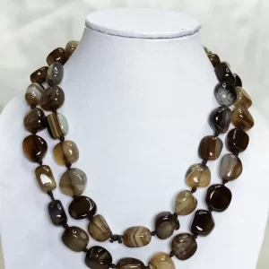 Brown Sugar - Delightful irregular tumbles of Onyx in all the shades of chocolate brown and mottled with white come together in this knotted 36” single strand necklace. DN0026