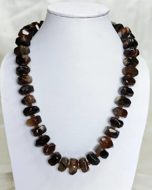 Browning Glory - Double cushion cut beads of Onyx in all shades of sandy and bark brown flecked with varying shades of white come together in this knotted 18” single strand necklace. DN0033