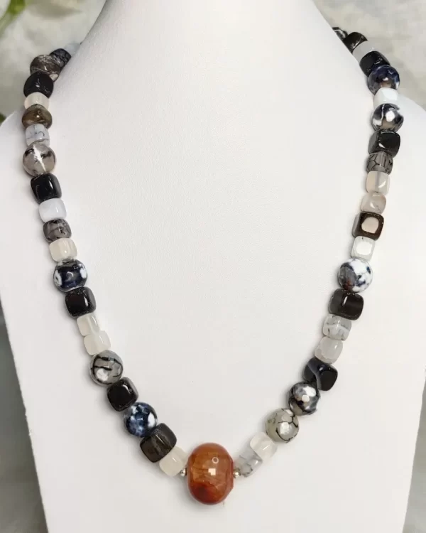 Shadow Suite – DN 0293 - A wonderfully wide collection of whites and blacks come together in this fetching 19” ensemble of Onyx white and black beads and cubes, with banding, splotching, and marbling patterns, griddled with dragon veins. A solitary, brightly coloured Onyx bead sets off the radiant blacks and whites.